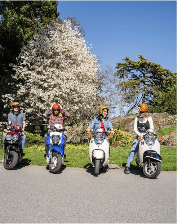 A group of scooters and riders parked in Victoria, BC