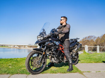 A rider on his parked motorcycle, overlooking Victoria’s waterfront