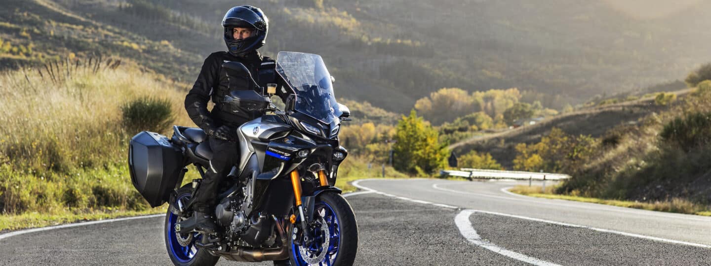 Tracer 9 GT with rider parked on the side of a curvy road