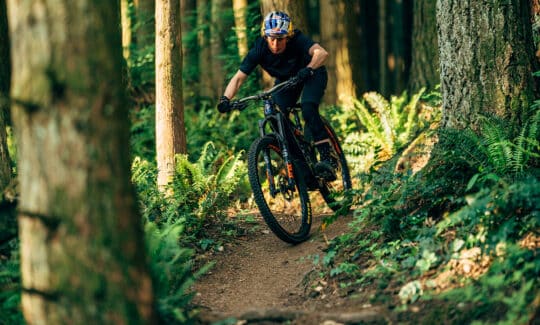 riding an electric mountain bike downhill on the northshore