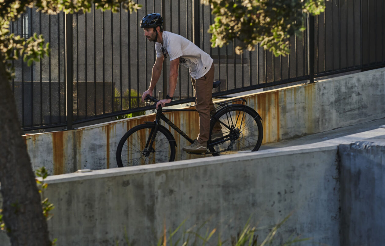 A man riding a giant escape bike down a ramp