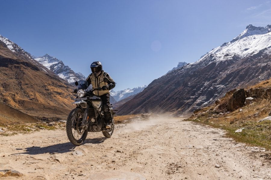 A rider in the mountains on a Royal Enfield Himalayan 450