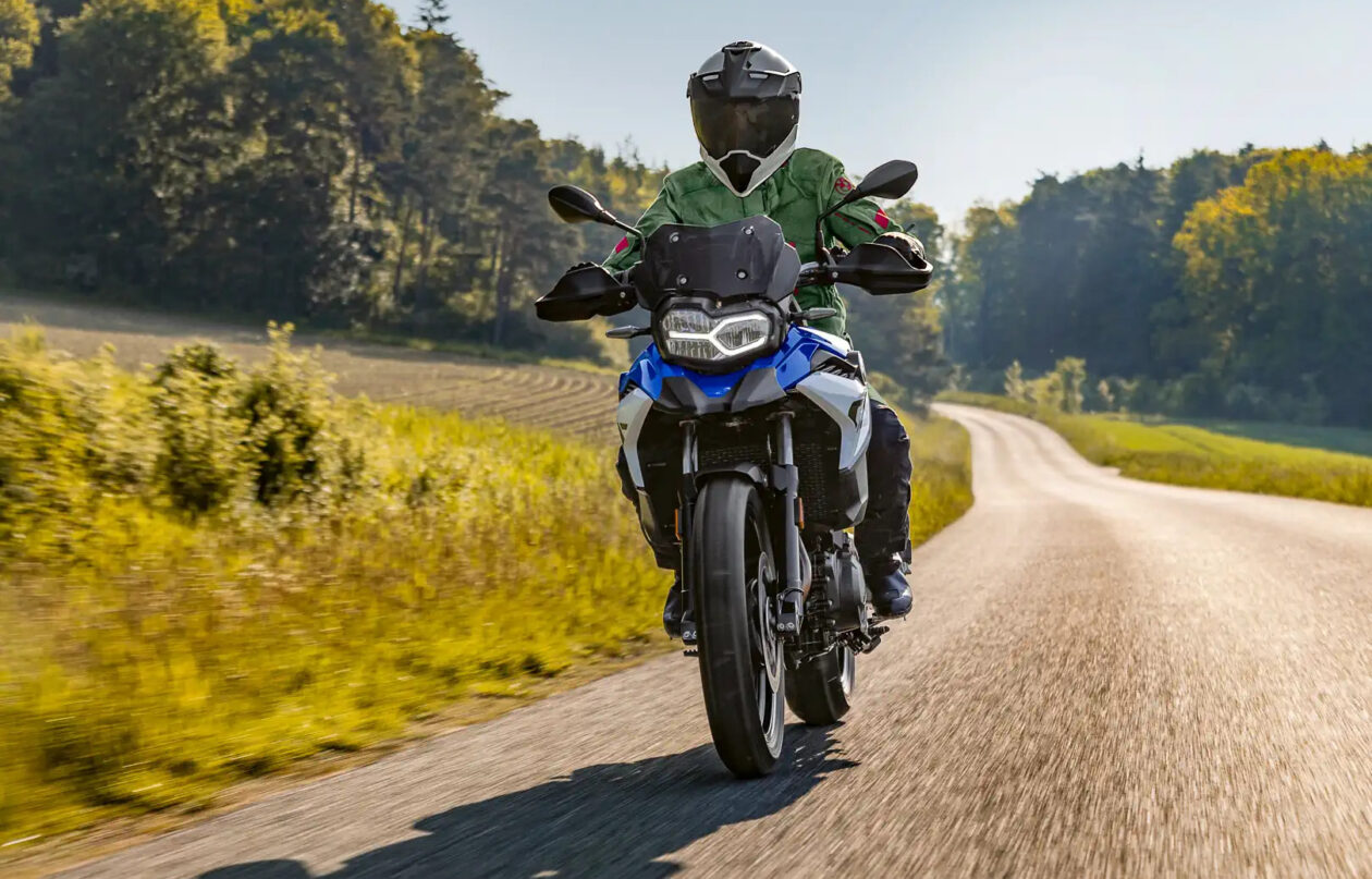 A motorcycle rider on a country road