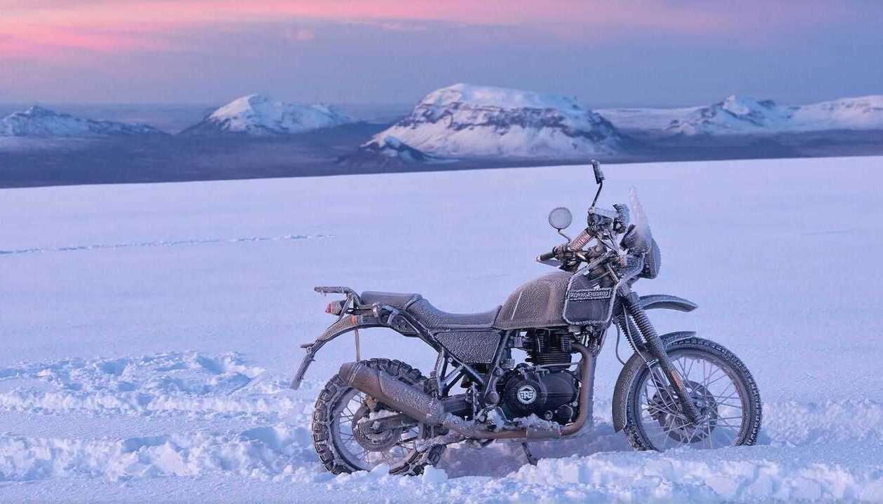 A motorcycle parked in the snow.