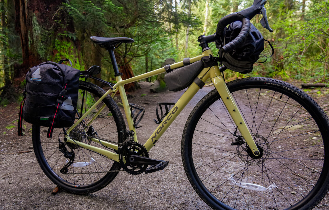 Loaded bike on forest trail in daylight.
