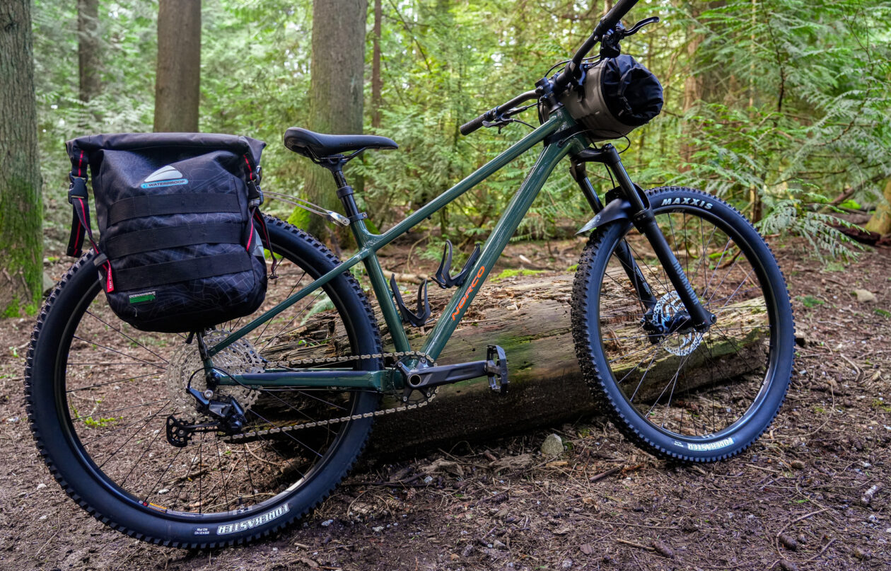 Mountain bike with panniers on forest trail