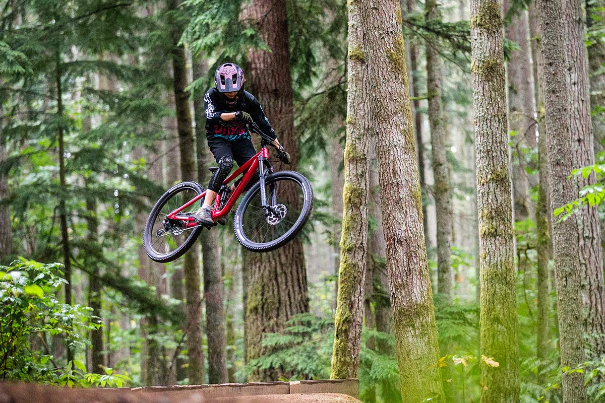 Mountain biker jumps on forest trail.