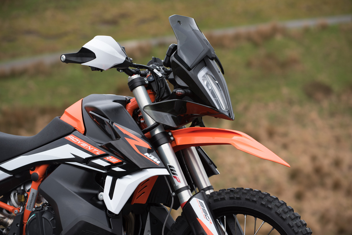 Orange adventure motorcycle parked outdoors