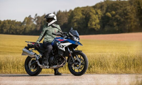 Rider on blue motorcycle in countryside