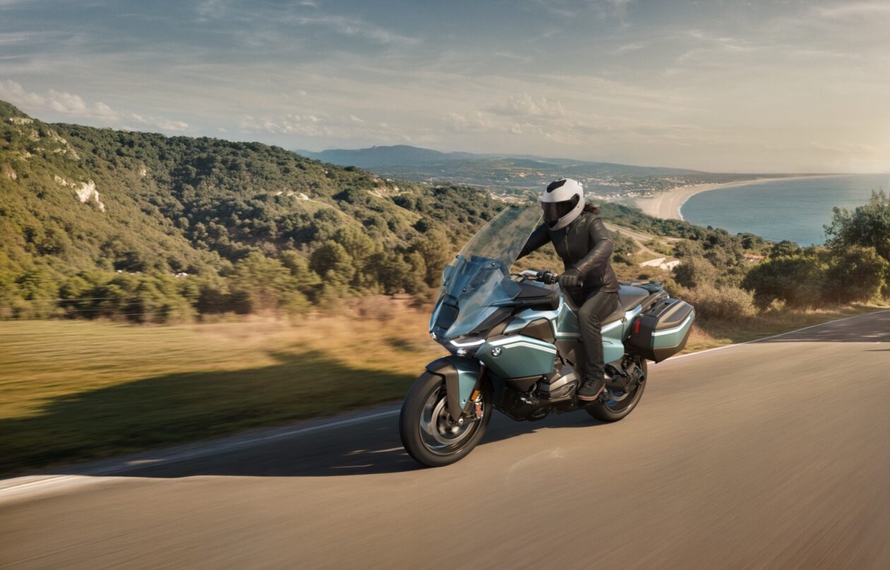 Motorcyclist rides on scenic coastal highway.